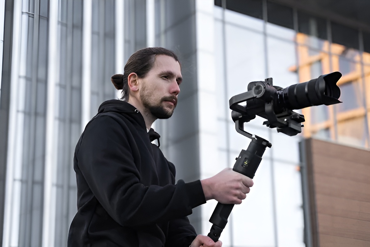 a person holding a camera on a gimbal