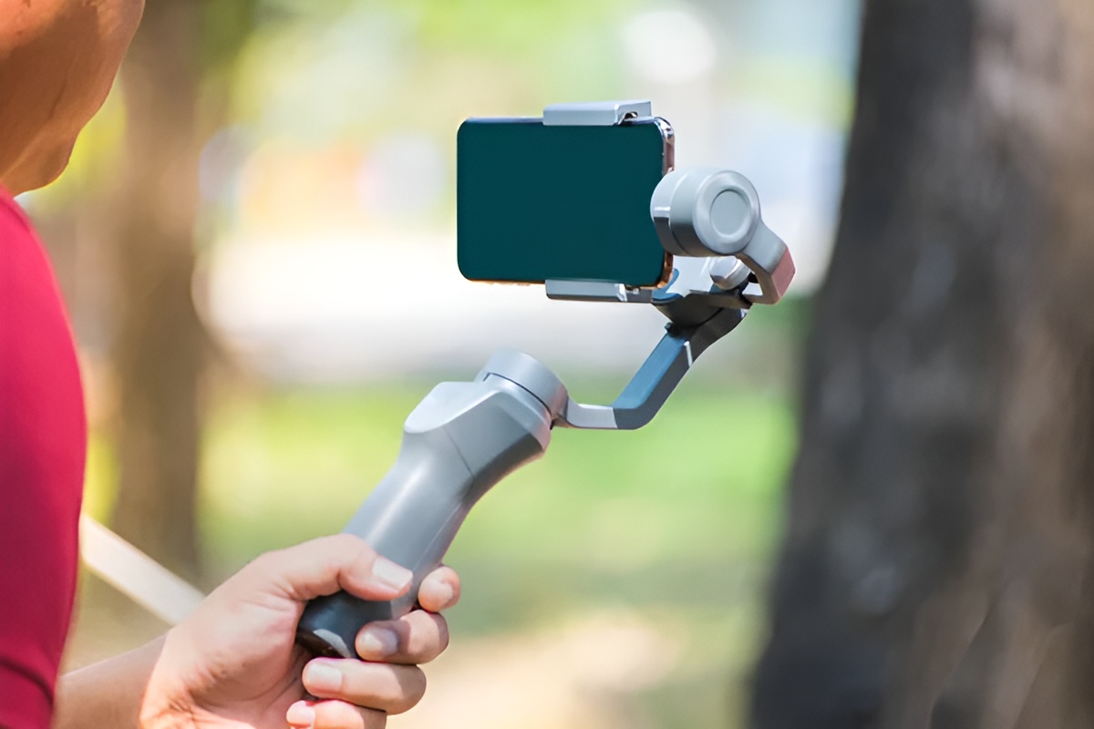 a person holding a camera phone on a gimbal